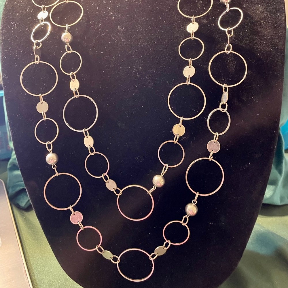 Long layered silver tone necklace with wire circles, circle discs and beads